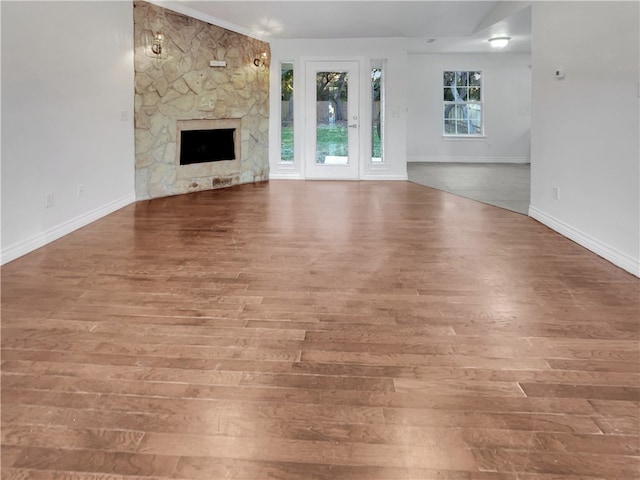 unfurnished living room with a fireplace and wood-type flooring