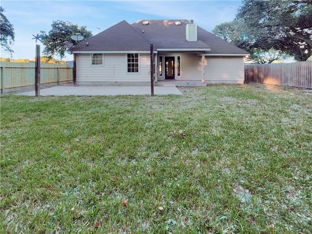 rear view of house with a patio area and a lawn