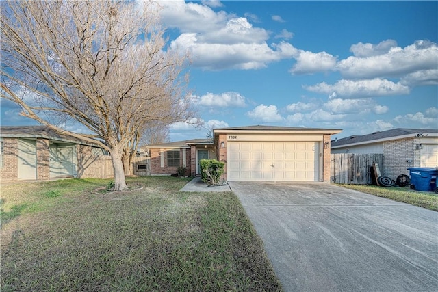 ranch-style home with a garage and a front yard