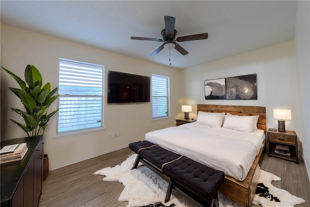 bedroom with ceiling fan and hardwood / wood-style floors