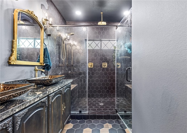 bathroom with tile patterned flooring, vanity, and a shower with shower door