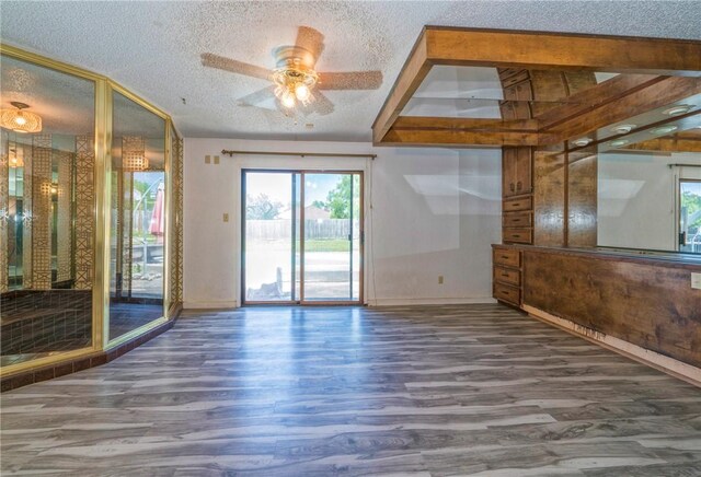 5490 County Road 73, Robstown, TX 78380 - spare room with wood finished floors, baseboards, ceiling fan, and a textured ceiling
