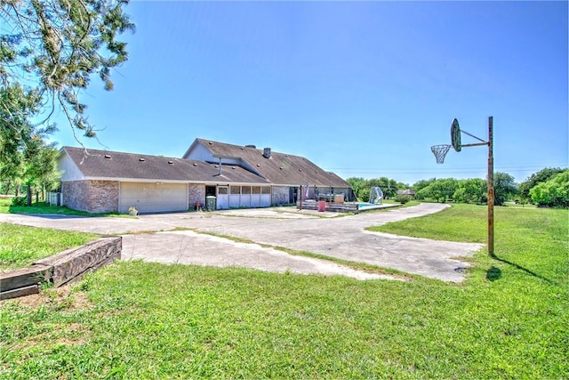 5490 County Road 73, Robstown, TX 78380 - view of green lawn featuring an attached garage and concrete driveway