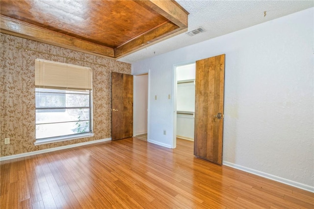 5490 County Road 73, Robstown, TX 78380 - spare room with wood finished floors, baseboards, a raised ceiling, and wallpapered walls