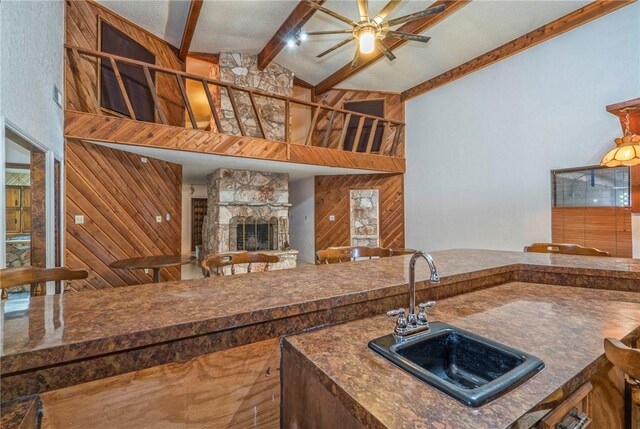5490 County Road 73, Robstown, TX 78380 - kitchen with a sink, ceiling fan, high vaulted ceiling, dark countertops, and beamed ceiling