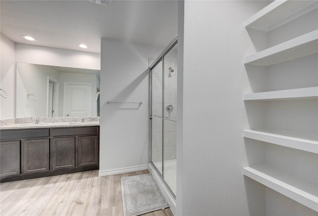 2721 Excelsior Blvd, Corpus Christi, TX 78415 - bathroom with a stall shower, double vanity, and wood finished floors