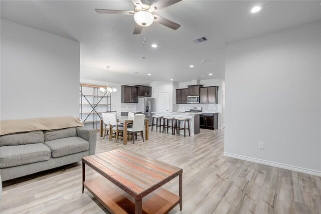 2721 Excelsior Blvd, Corpus Christi, TX 78415 - living area with a ceiling fan, light wood-type flooring, a chandelier, and recessed lighting