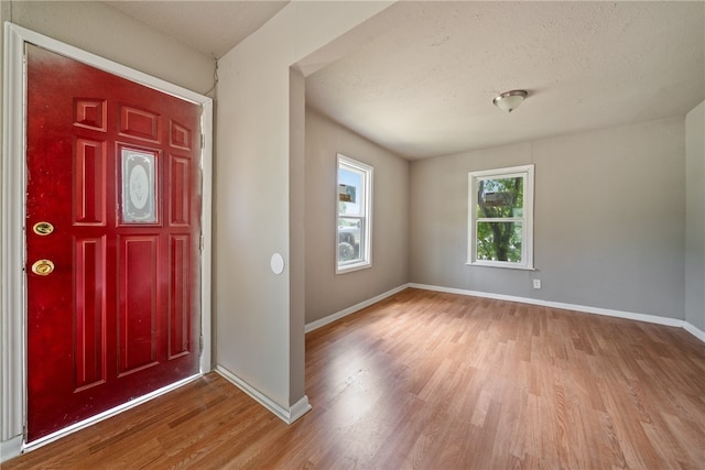 entryway featuring wood-type flooring and a textured ceiling