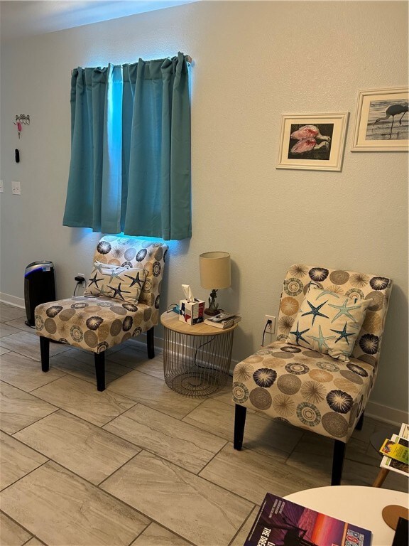 sitting room with hardwood / wood-style flooring