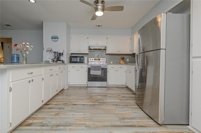 19 Estates Dr, Rockport, TX 78382 - kitchen featuring stainless steel appliances, ceiling fan, white cabinets, and light wood-style floors