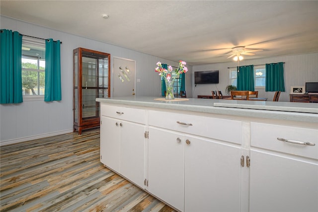 kitchen featuring ceiling fan, white cabinetry, and light wood-type flooring