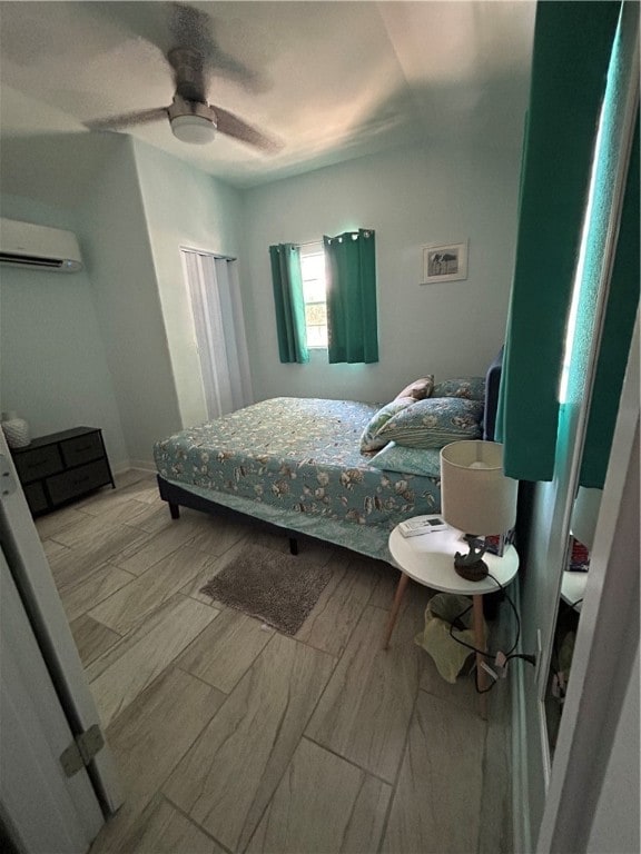 bedroom featuring a wall unit AC and ceiling fan