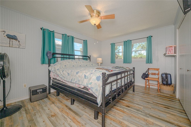 bedroom with ceiling fan and light hardwood / wood-style flooring