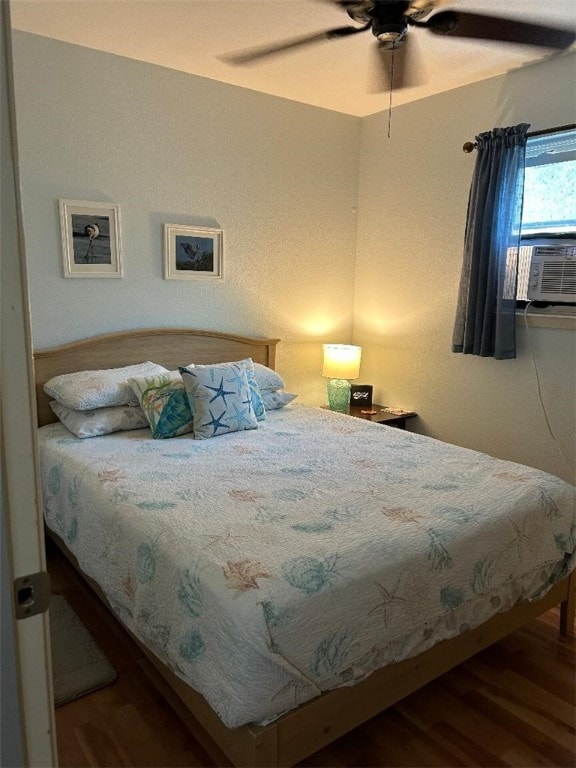 bedroom featuring hardwood / wood-style flooring, ceiling fan, and cooling unit