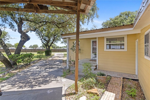 view of exterior entry featuring a patio area