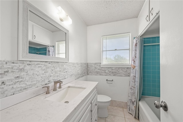4122 Barnes St, Corpus Christi, TX 78411 - full bath featuring healthy amount of natural light, vanity, a textured ceiling, tile patterned floors, and shower / tub combo with curtain