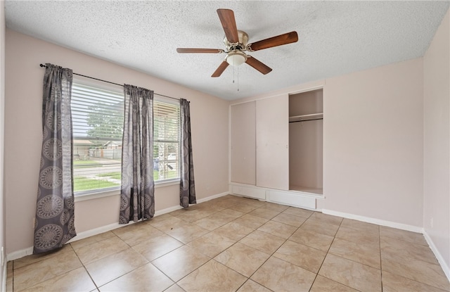 4122 Barnes St, Corpus Christi, TX 78411 - unfurnished bedroom featuring a textured ceiling, light tile patterned flooring, ceiling fan, and a closet