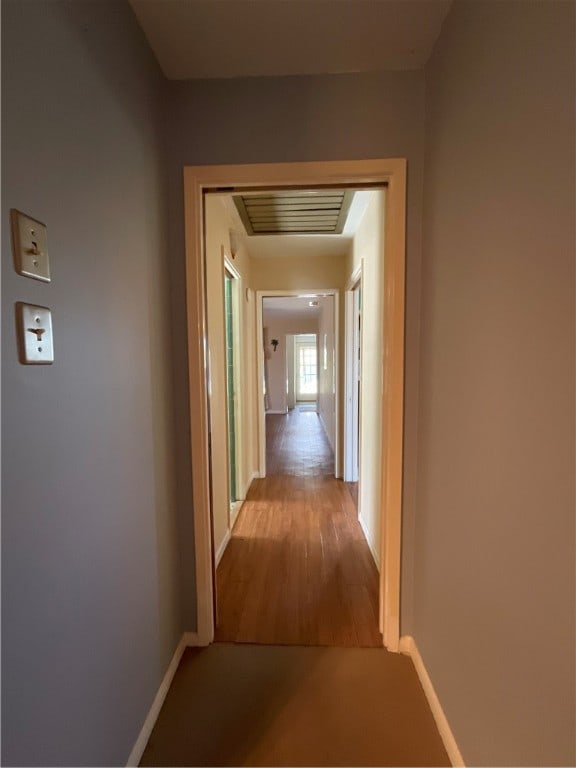 corridor with light wood-type flooring