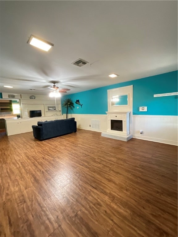 unfurnished living room featuring hardwood / wood-style floors and ceiling fan