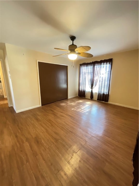 empty room featuring hardwood / wood-style floors and ceiling fan