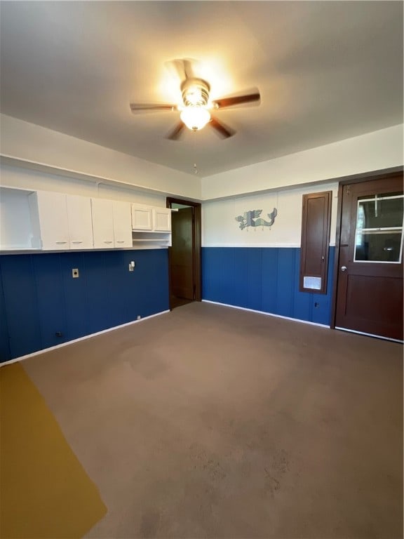 interior space with concrete floors and ceiling fan