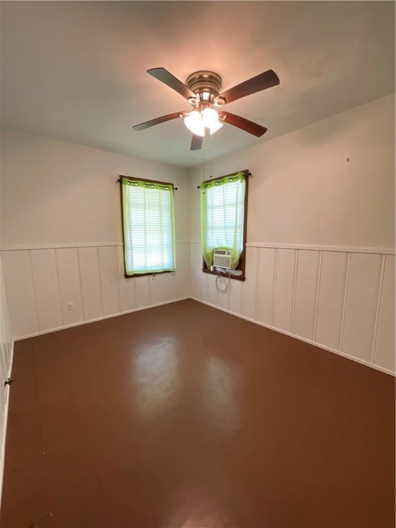 unfurnished room featuring cooling unit and ceiling fan