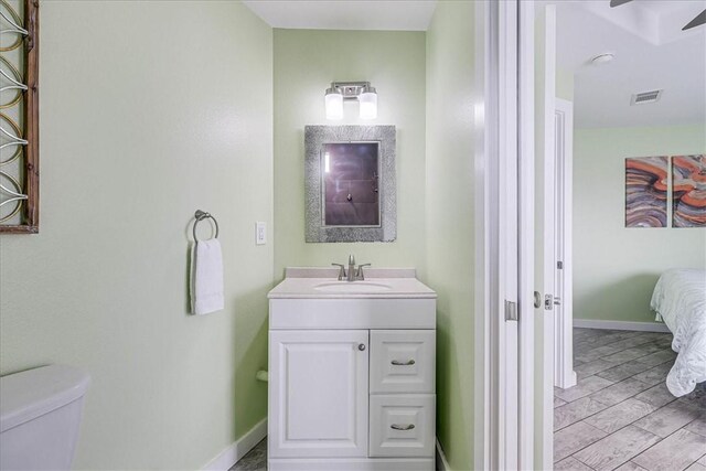1923 S 11th St Unit 1, Port Aransas, TX 78373 - bathroom featuring vanity, toilet, and baseboards