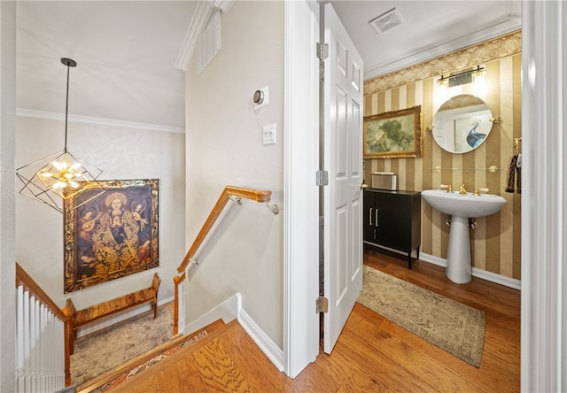 4270 Ocean Dr Unit 11, Corpus Christi, TX 78411 - stairs with wallpapered walls, wood finished floors, a chandelier, and crown molding