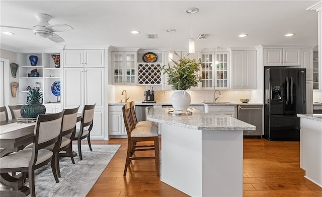 4270 Ocean Dr Unit 11, Corpus Christi, TX 78411 - kitchen featuring black refrigerator with ice dispenser, dishwasher, white cabinets, pendant lighting, and recessed lighting