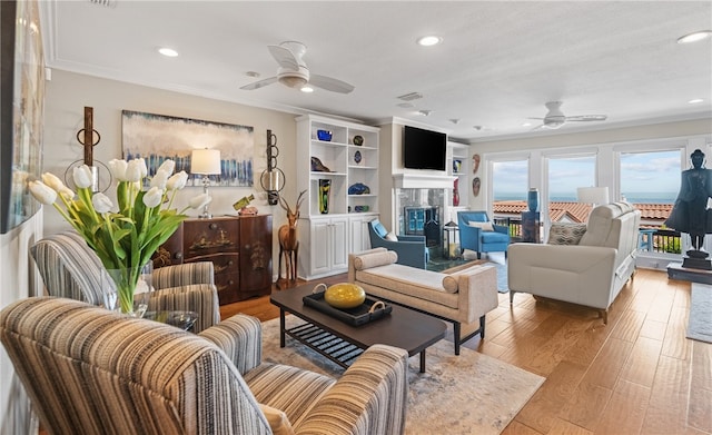 4270 Ocean Dr Unit 11, Corpus Christi, TX 78411 - living area featuring ceiling fan, a glass covered fireplace, recessed lighting, wood finished floors, and ornamental molding