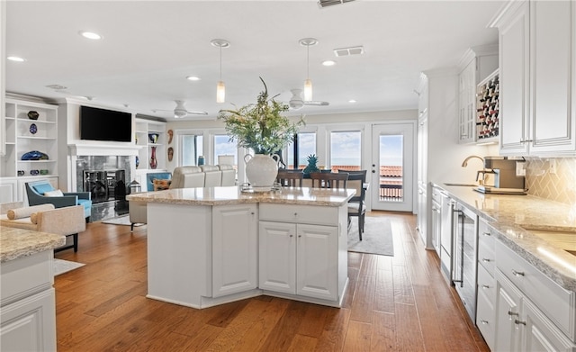 4270 Ocean Dr Unit 11, Corpus Christi, TX 78411 - kitchen with a kitchen island, white cabinets, ceiling fan, light wood finished floors, and recessed lighting