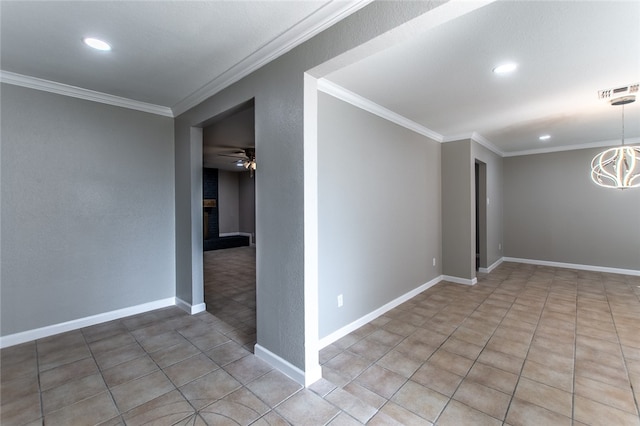 empty room featuring tile patterned floors, a fireplace, ceiling fan with notable chandelier, and ornamental molding