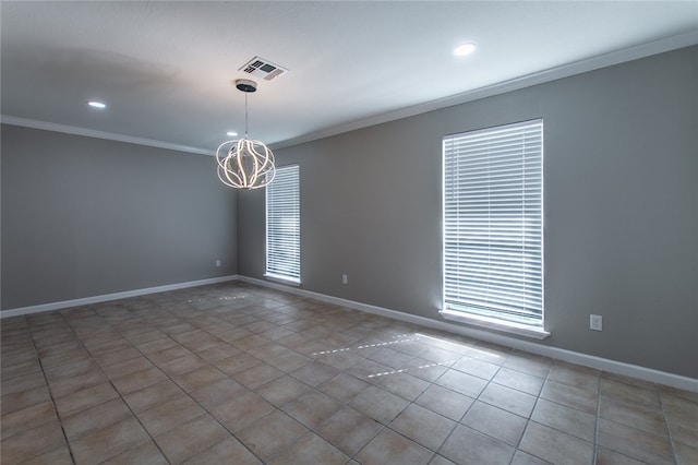 empty room featuring tile patterned flooring, crown molding, a wealth of natural light, and an inviting chandelier