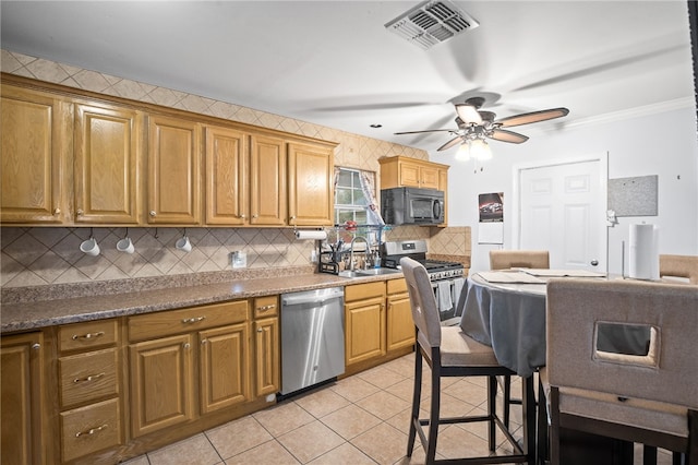 kitchen featuring sink, ceiling fan, stainless steel appliances, tasteful backsplash, and light tile patterned flooring