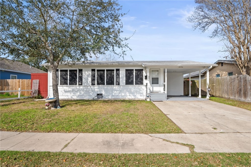 single story home with a carport and a front yard