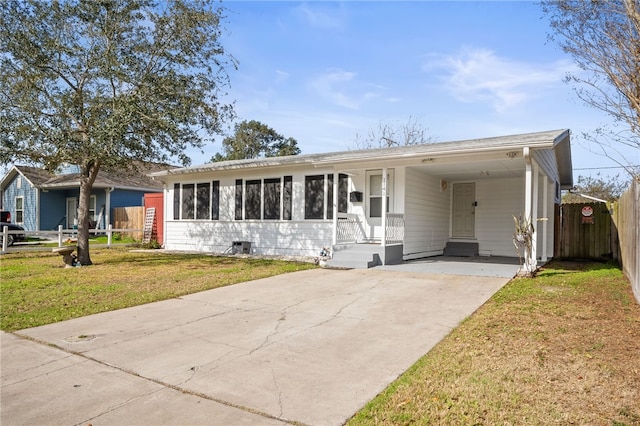 ranch-style house featuring a front yard and a carport