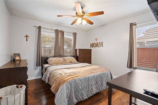 bedroom with dark hardwood / wood-style flooring and ceiling fan