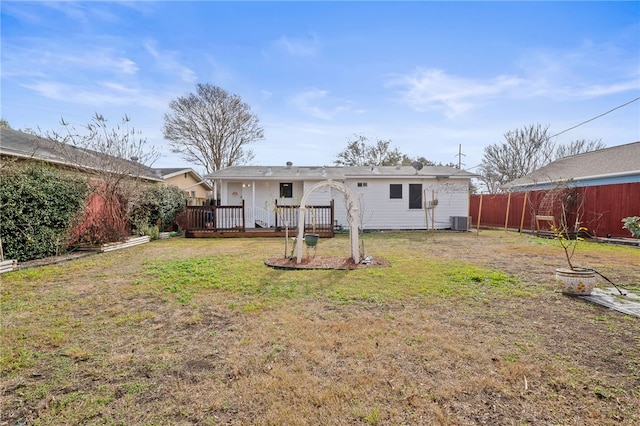 rear view of property featuring a yard and central air condition unit