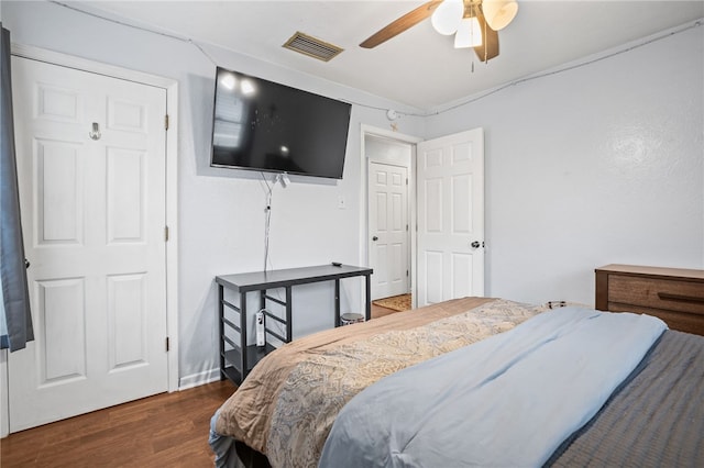 bedroom with dark wood-type flooring and ceiling fan