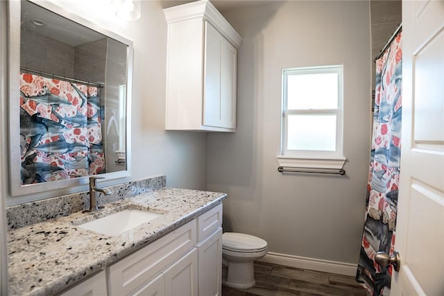 bathroom featuring toilet, hardwood / wood-style floors, and vanity