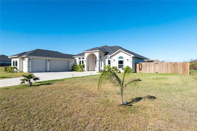 single story home with a garage and a front lawn