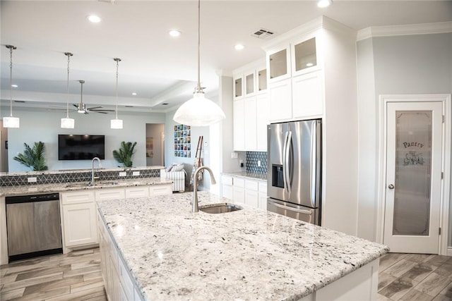 kitchen featuring ceiling fan, white cabinetry, stainless steel appliances, and pendant lighting