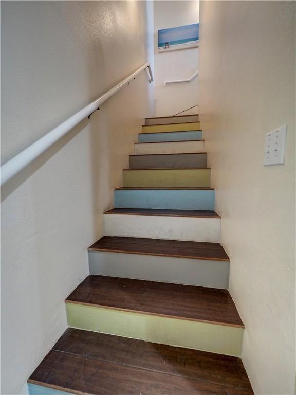 staircase with hardwood / wood-style floors