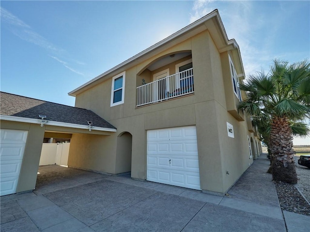 exterior space with a garage and a balcony