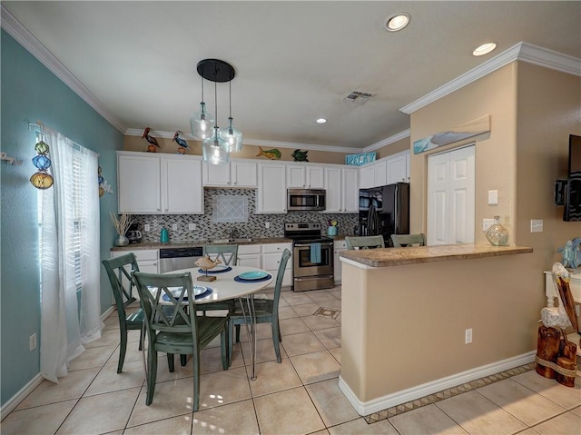 kitchen featuring pendant lighting, white cabinets, light tile patterned floors, kitchen peninsula, and stainless steel appliances