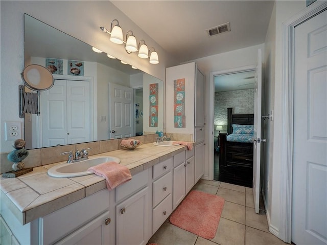 bathroom featuring tile patterned flooring and vanity