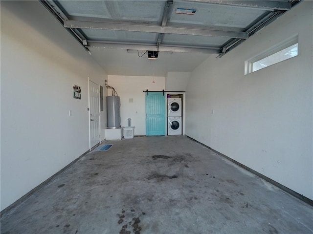 garage with a garage door opener, stacked washing maching and dryer, and water heater