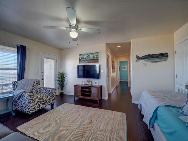 living room featuring dark hardwood / wood-style floors and ceiling fan