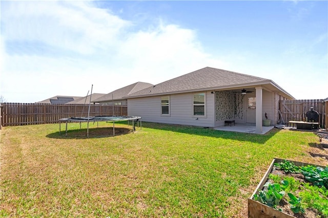 7706 Iron Man, Corpus Christi, TX 78414 - back of house with a patio, a fenced backyard, ceiling fan, a trampoline, and a yard