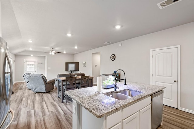 7706 Iron Man, Corpus Christi, TX 78414 - kitchen with visible vents, stainless steel appliances, light wood-type flooring, white cabinetry, and a sink